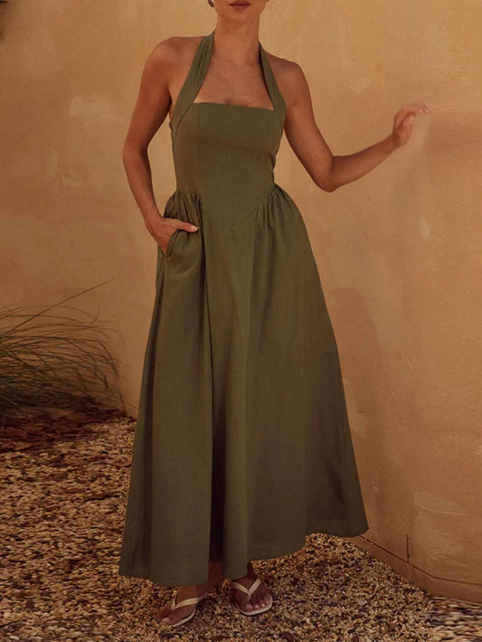 Halter neck maxi dress with ruched detail and pockets, opaque polyester fabric, machine washable.
