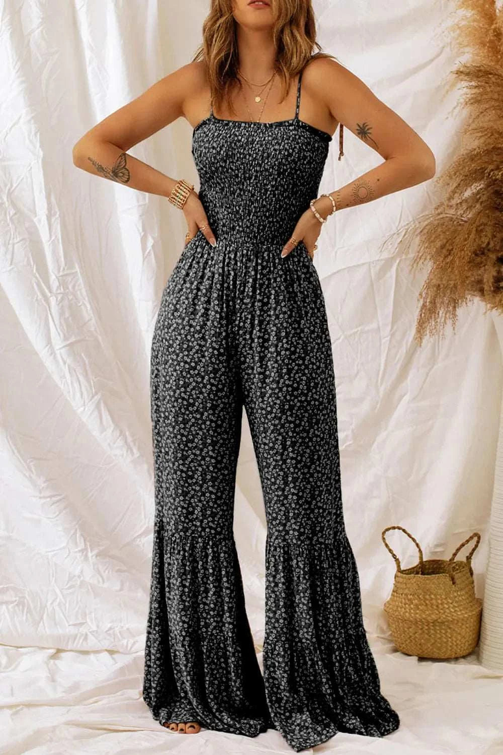Floral spaghetti strap wide leg jumpsuit in vibrant floral print with adjustable straps and flowing polyester fabric