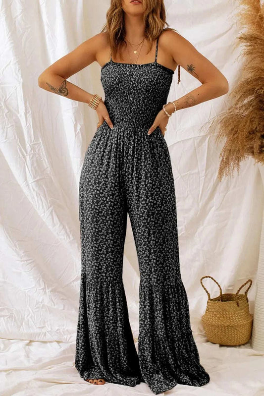 Floral spaghetti strap wide leg jumpsuit in vibrant floral print with adjustable straps and flowing polyester fabric